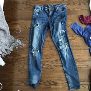 Distressed blue skinny jeans